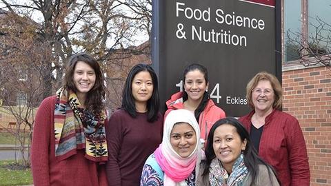 nutrition students and instructors in front of FScN sign