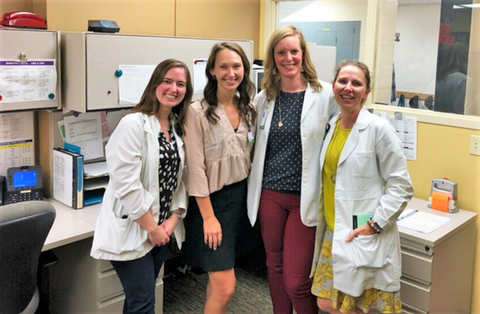 interns with dietitians in hospital wearing white coats MNT